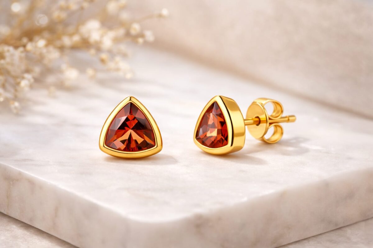 Elegant sterling silver earrings with fiery red triangular gemstones. Perfect for a sophisticated an.