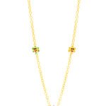 Delicate gold chain with colorful star and smiley face charms, perfect for children.