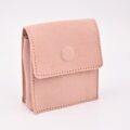 Soft pink jewelry pouch with a subtle embossed logo for delicate accessories.
