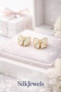 Delicate white bow earrings with gold outline for kids and teens.