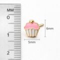 Cute pink cupcake earrings with gold accents for children.