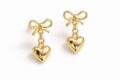 Elegant gold heart dangle earrings with bow detail for women and teens.