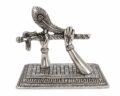 Silver sculpture of Krishna's hands holding a flute on a decorative base.