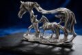 Elegant silver horse figurine with detailed craftsmanship for jewelry showcase.