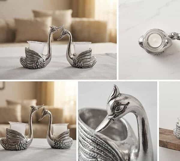 Close-up of silver swan-shaped earrings with intricate details.