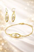 Gold earrings and bracelet with small diamonds for women and teens.