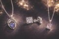 Silver jewelry set with tanzanite and cubic zirconia stones on dark background.
