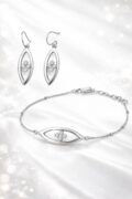 Sterling silver earrings and bracelet with floral design on a white background.