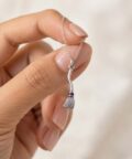 Delicate silver broom charm pendant close-up
