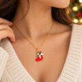 Gold Santa hat pendant on chain against cozy sweater.