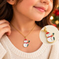 Girl wearing a gold chain with a snowman pendant.