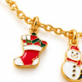 Gold-tone bracelet chain with Christmas stocking charm and snowman charm.