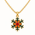 Gold snowflake pendant with red and orange enamel accents on chain.