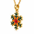 Gold snowflake pendant with red and orange enamel accents on a gold chain.