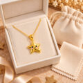 Elegant gold star pendant necklace in jewelry box.