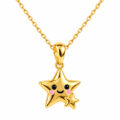 Gold star pendant necklace with cute face and smaller star charm.
