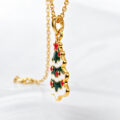 Gold-plated Christmas tree pendant with red and green enamel accents on a delicate chain.