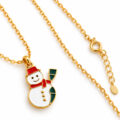 Gold snowman pendant on a delicate chain with red scarf.