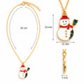 Gold snowman pendant necklace with red scarf and green accents.