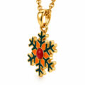 Gold snowflake pendant with red center on a chain, holiday jewelry accessory.